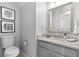 Cozy bathroom with framed mirror, granite counters and white fixtures at 1785 Rushden Dr, Ocoee, FL 34761