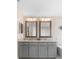 Modern bathroom with dual sinks, marble counters, and a soaking tub at 1785 Rushden Dr, Ocoee, FL 34761