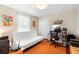 Bright bedroom with a white futon, a wooden desk with computer and an orange rug at 1785 Rushden Dr, Ocoee, FL 34761