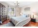 Comfortable bedroom with hardwood floors, a cozy queen-sized bed, and ample natural light creating a tranquil retreat at 1785 Rushden Dr, Ocoee, FL 34761