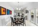 Dining area adjacent to the kitchen with glass table and access to lanai at 1785 Rushden Dr, Ocoee, FL 34761