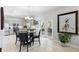Dining area adjacent to the kitchen with glass table and access to lanai at 1785 Rushden Dr, Ocoee, FL 34761