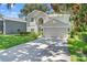 Charming two-story home with a lush green lawn, mature trees, and a convenient two-car garage at 1785 Rushden Dr, Ocoee, FL 34761