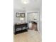 Hallway view leading to main bedroom with wood floors, transom window, and small accent table at 1785 Rushden Dr, Ocoee, FL 34761