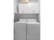 Practical laundry room with stacked washer and dryer, and overhead cabinets at 1785 Rushden Dr, Ocoee, FL 34761