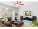 Bright and airy living room features a modern entertainment setup, tile floors, and a neutral color palette at 1785 Rushden Dr, Ocoee, FL 34761