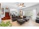 Spacious living room with tile flooring, a comfortable sectional, and a view into the modern kitchen at 1785 Rushden Dr, Ocoee, FL 34761