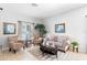 Comfortable living room with patterned armchairs, a neutral sofa, and large windows creating an inviting and bright space at 1785 Rushden Dr, Ocoee, FL 34761