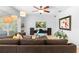 Close-up view of a living room with tile floors, textured wall, modern entertainment center, and neutral decor at 1785 Rushden Dr, Ocoee, FL 34761
