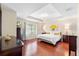 Spacious bedroom with tray ceiling, hardwood floors and a chandelier at 1785 Rushden Dr, Ocoee, FL 34761