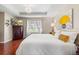 Bedroom featuring hardwood floors, a tray ceiling, a chandelier, and a window at 1785 Rushden Dr, Ocoee, FL 34761