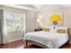 Bright bedroom with hardwood floors, tray ceiling, chandelier and window at 1785 Rushden Dr, Ocoee, FL 34761