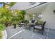 Enjoy this outdoor patio featuring modern furniture, serene landscaping and shade at 1785 Rushden Dr, Ocoee, FL 34761