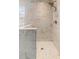 Contemporary marble-tiled walk-in shower featuring a rainfall shower head and mosaic tile floor at 1785 Rushden Dr, Ocoee, FL 34761