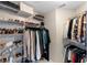 Functional walk-in closet with multiple shelves and hanging rods for organized storage at 1785 Rushden Dr, Ocoee, FL 34761