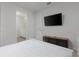 Bedroom featuring a TV, dresser, and an open doorway to the bathroom at 1811 Caribbean View Ter, Kissimmee, FL 34747