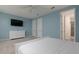 Spacious bedroom with light blue walls, ceiling fan, ensuite bath access, and lots of natural light at 1811 Caribbean View Ter, Kissimmee, FL 34747