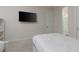 Bedroom with a TV mounted on the wall and view to a Primary bath at 1811 Caribbean View Ter, Kissimmee, FL 34747