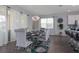 Bright dining area with a modern light fixture, seating for six, and access to the kitchen at 1811 Caribbean View Ter, Kissimmee, FL 34747