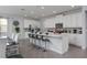 Open-concept kitchen with white cabinetry, stainless steel appliances, and a large center island at 1811 Caribbean View Ter, Kissimmee, FL 34747