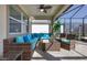 Inviting screened-in lanai featuring comfortable seating and a ceiling fan at 1811 Caribbean View Ter, Kissimmee, FL 34747