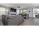 Spacious living room with plush seating, a sleek ceiling fan, and access to the outdoor patio at 1811 Caribbean View Ter, Kissimmee, FL 34747