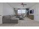 Upstairs living room featuring a gray sectional sofa and eye-catching wall décor at 1811 Caribbean View Ter, Kissimmee, FL 34747
