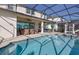 Sparkling pool area with ample seating, a jacuzzi and a screened-in enclosure at 1811 Caribbean View Ter, Kissimmee, FL 34747