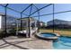 Inviting screened pool area with lounge bed, spa, and lush landscaping offers a relaxing outdoor retreat at 1811 Caribbean View Ter, Kissimmee, FL 34747
