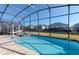 Beautiful screened pool with a lounge area creates a perfect outdoor space for relaxation and entertaining at 1811 Caribbean View Ter, Kissimmee, FL 34747