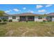 A well-maintained backyard with a view of the home's screened in patio, ideal for outdoor living at 1841 Overcup Ave, St Cloud, FL 34769