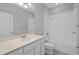 Well-lit bathroom with white vanity, quartz countertop, tiled shower-tub combo and hardware at 1841 Overcup Ave, St Cloud, FL 34769