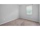 Neutral bedroom featuring carpeted floors, window and base molding at 1841 Overcup Ave, St Cloud, FL 34769