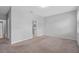 This is an empty bedroom with neutral walls, carpeting and trim; adjacent to a doorway at 1841 Overcup Ave, St Cloud, FL 34769