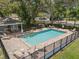 A community pool framed by mature trees provides a refreshing oasis for residents to enjoy at 1841 Overcup Ave, St Cloud, FL 34769