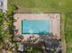 Aerial shot showcasing a fenced community swimming pool with lounge chairs for relaxation on sunny days at 1841 Overcup Ave, St Cloud, FL 34769