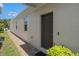 Inviting side entrance featuring neutral stucco and a pathway leading to the front door at 1841 Overcup Ave, St Cloud, FL 34769