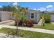 Well-maintained home with lush lawn, complemented by mature trees and colorful foliage at 1841 Overcup Ave, St Cloud, FL 34769