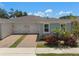 Charming home showcasing a two-car garage, brick driveway, and colorful landscaping at 1841 Overcup Ave, St Cloud, FL 34769