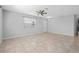 Spacious open floor plan with tile floors, large window, and ceiling fan at 1841 Overcup Ave, St Cloud, FL 34769
