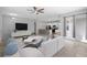 Staged living room with modern furniture open to kitchen with bar seating and stainless appliances at 1841 Overcup Ave, St Cloud, FL 34769
