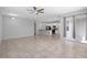 Expansive living room open to kitchen featuring modern tile flooring and neutral color palette at 1841 Overcup Ave, St Cloud, FL 34769