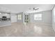 Bright, open living space featuring tile floors, a ceiling fan, and a kitchen view at 1841 Overcup Ave, St Cloud, FL 34769