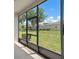 This is a screened patio that overlooks a green grass yard and trees in the background at 1841 Overcup Ave, St Cloud, FL 34769