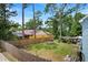 Large fenced backyard with ample space, trees, a shed, and multiple dwellings at 201 Garden Ln, Longwood, FL 32750
