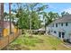 Large fenced backyard showcasing the property's spacious grounds, trees, and detached shed at 201 Garden Ln, Longwood, FL 32750