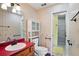 Charming bathroom with a red countertop, updated fixtures, and a convenient walk-in shower at 201 Garden Ln, Longwood, FL 32750