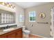 Well-lit bathroom features a granite vanity top and decorative nautical accents at 201 Garden Ln, Longwood, FL 32750