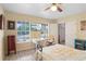 A bright bedroom showcasing large windows, a ceiling fan, a desk, and ample natural light at 201 Garden Ln, Longwood, FL 32750