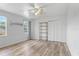 This spare bedroom offers a simple aesthetic with wood floors, a ceiling fan, and a closet at 201 Garden Ln, Longwood, FL 32750